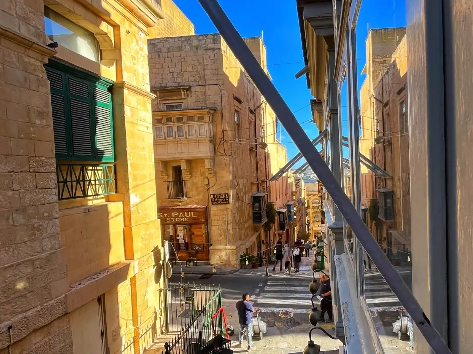 Sunny street view in Valletta, Malta, showcasing traditional architecture and vibrant surroundings, ideal for property management services